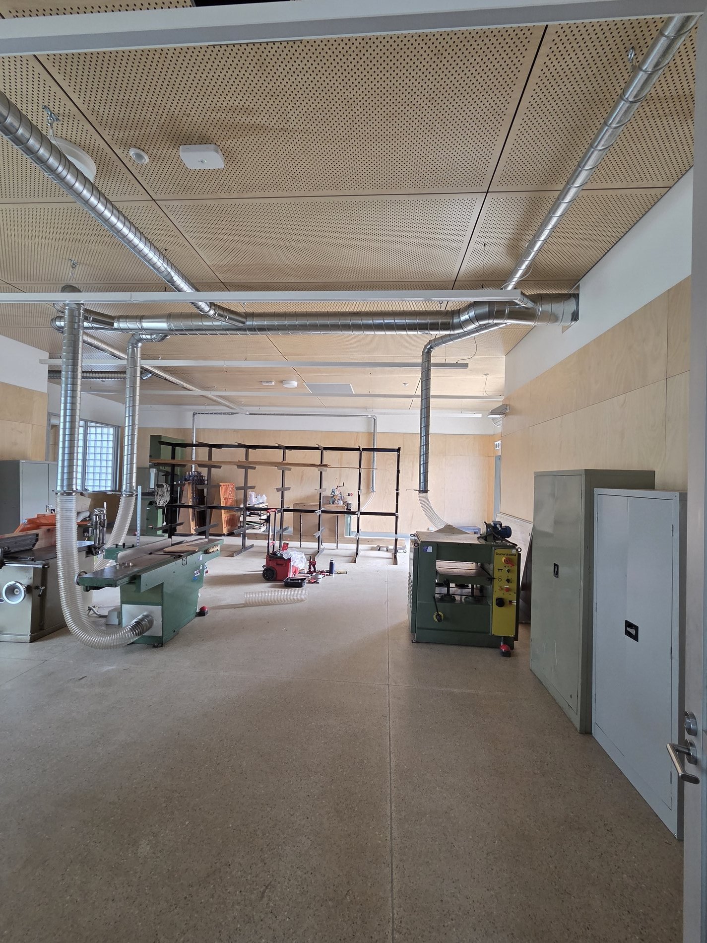 North-west Melbourne school workshop dust extraction system with overhead ducting and machine drops