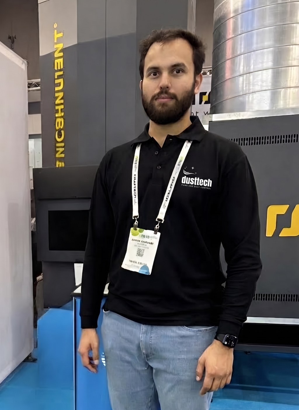 Sagar Goswami, Dusttech Director, standing beside industrial dust and fume extraction equipment