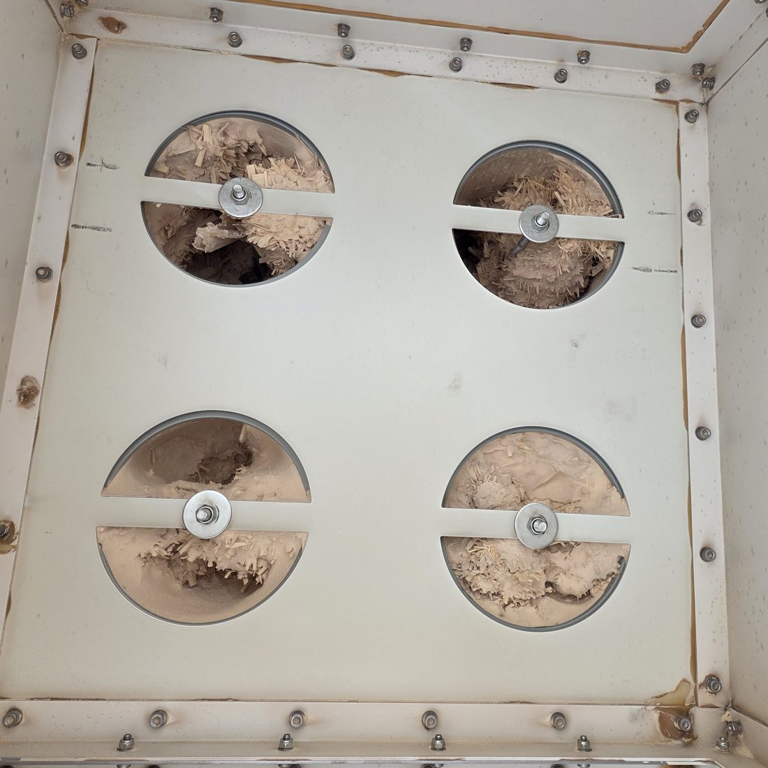 Dust extractor filter openings blocked with wood dust before servicing