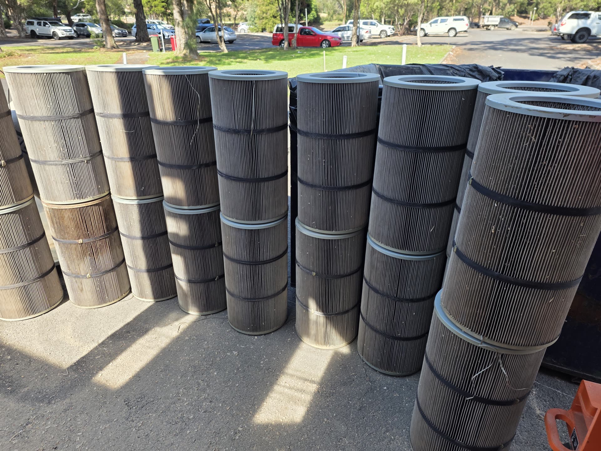 Row of used dust collector cartridge filters removed during a filter replacement service